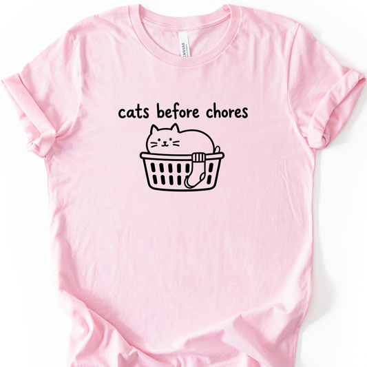Cats Before Chores T-Shirt in Soft Pink with black cat in a laundry basket.
