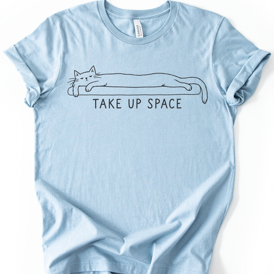 Take Up Space Cat T-Shirt in Light Blue with long lounging cat graphic.
