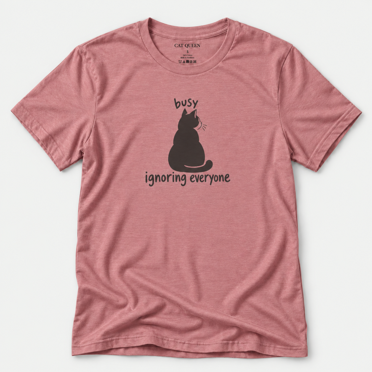 Busy Ignoring Everyone T-Shirt in Heather Mauve with black back-facing cat and text design.
