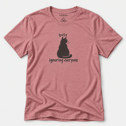 Busy Ignoring Everyone T-Shirt in Heather Mauve with black back-facing cat and text design.