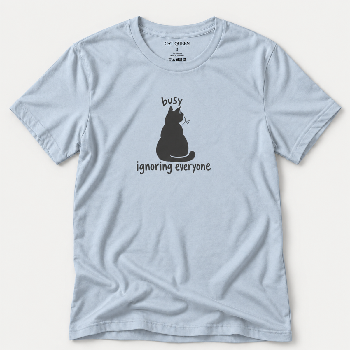 Busy Ignoring Everyone T-Shirt in Light Blue with black back-facing cat and text design.