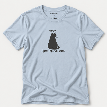 Busy Ignoring Everyone T-Shirt in Light Blue with black back-facing cat and text design.