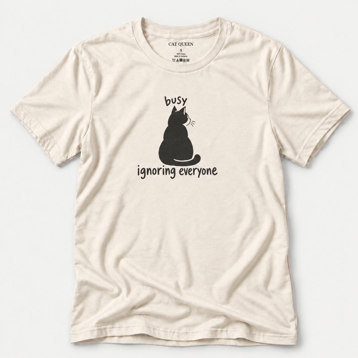 Busy Ignoring Everyone T-Shirt in Natural with black back-facing cat and text design.