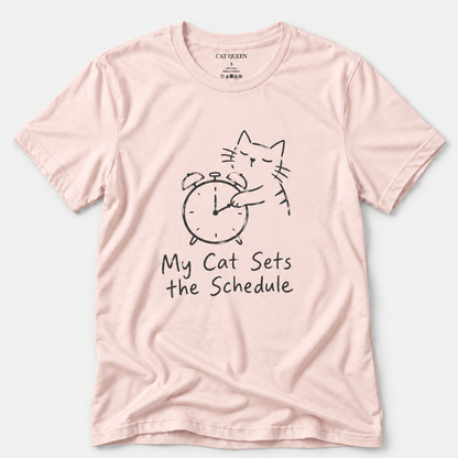 Cat Sets the Schedule T-Shirt in Soft Pink with cat on an alarm clock graphic.