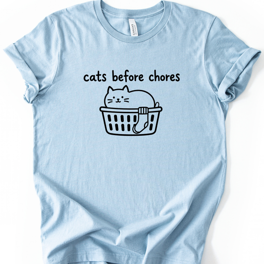 Cats Before Chores T-Shirt in Light Blue with black cat in a laundry basket.