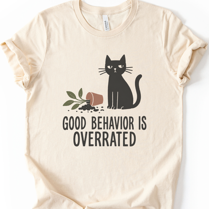 Good Behavior Cat T-Shirt in Natural with black cat and knocked-over plant graphic.
