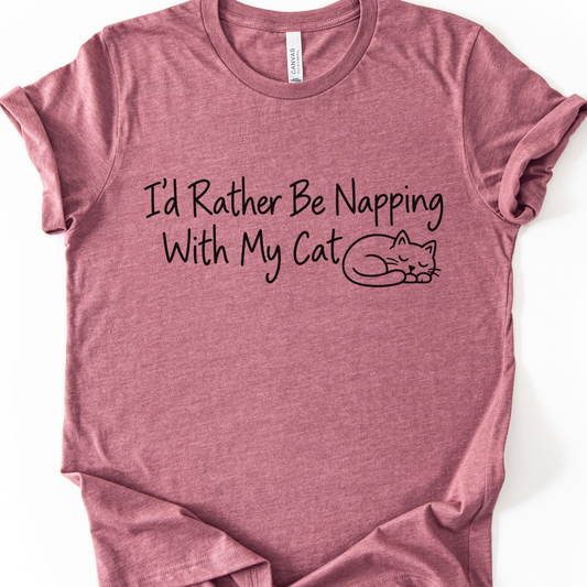 I’d Rather Be Napping With My Cat T-Shirt in Heather Mauve with black sleeping cat and lettering.