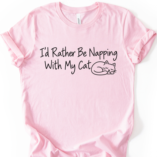 I’d Rather Be Napping With My Cat T-Shirt in Soft Pink with black sleeping cat and lettering.