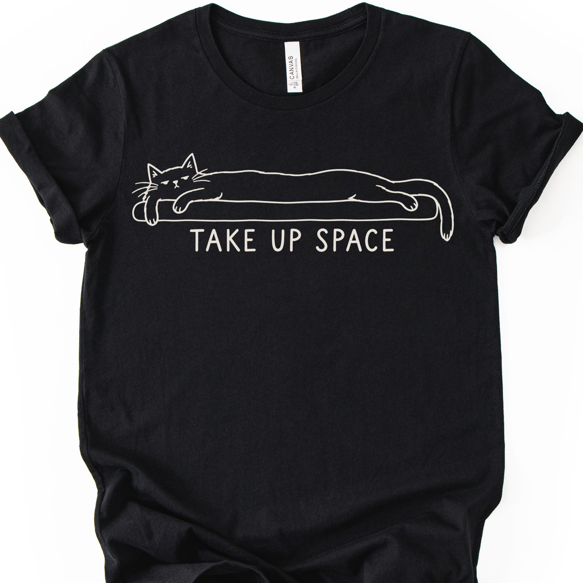 Take Up Space Cat T-Shirt in Black with long lounging cat graphic.