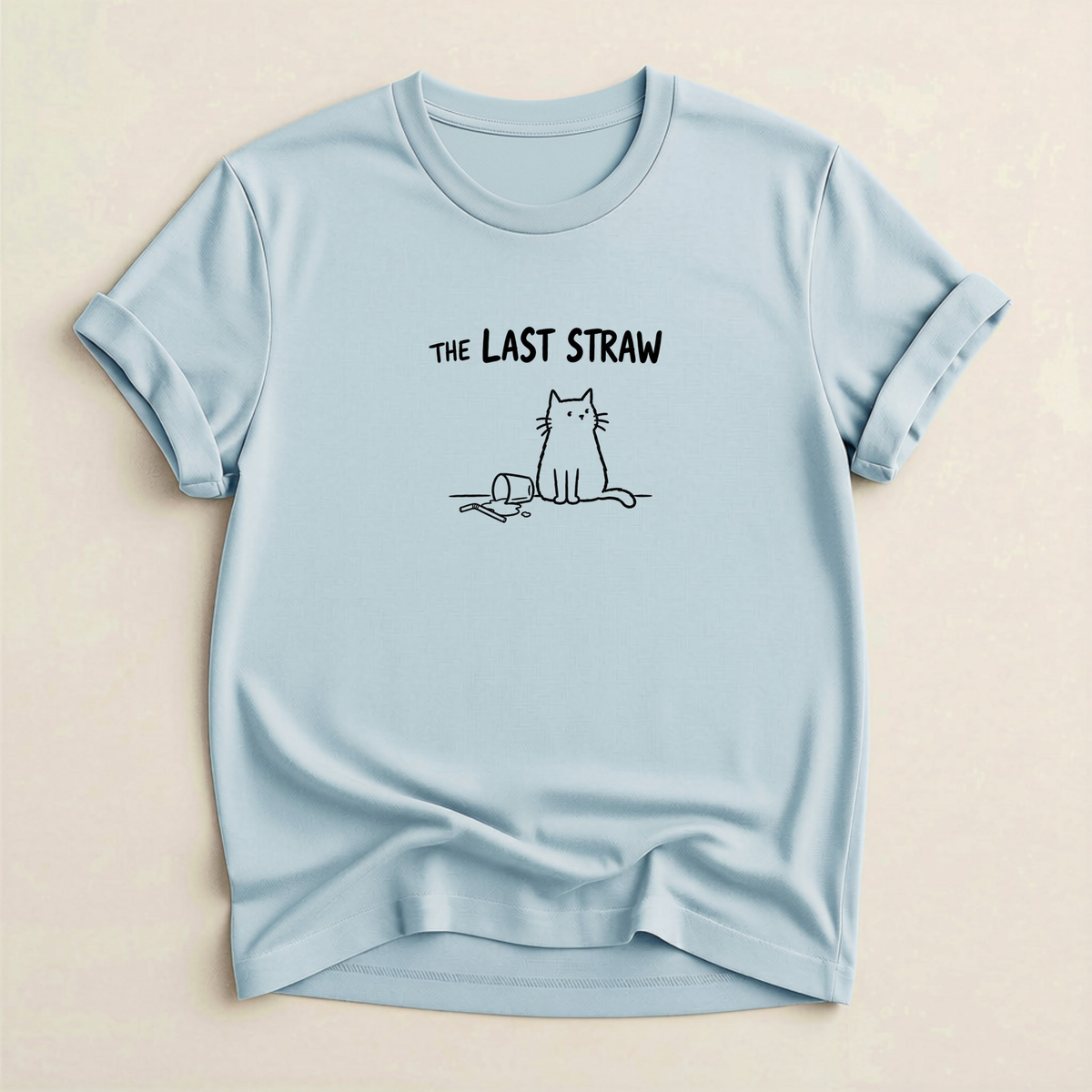 The Last Straw Cat T-Shirt in Light Blue with black cat and knocked-over glass graphic.