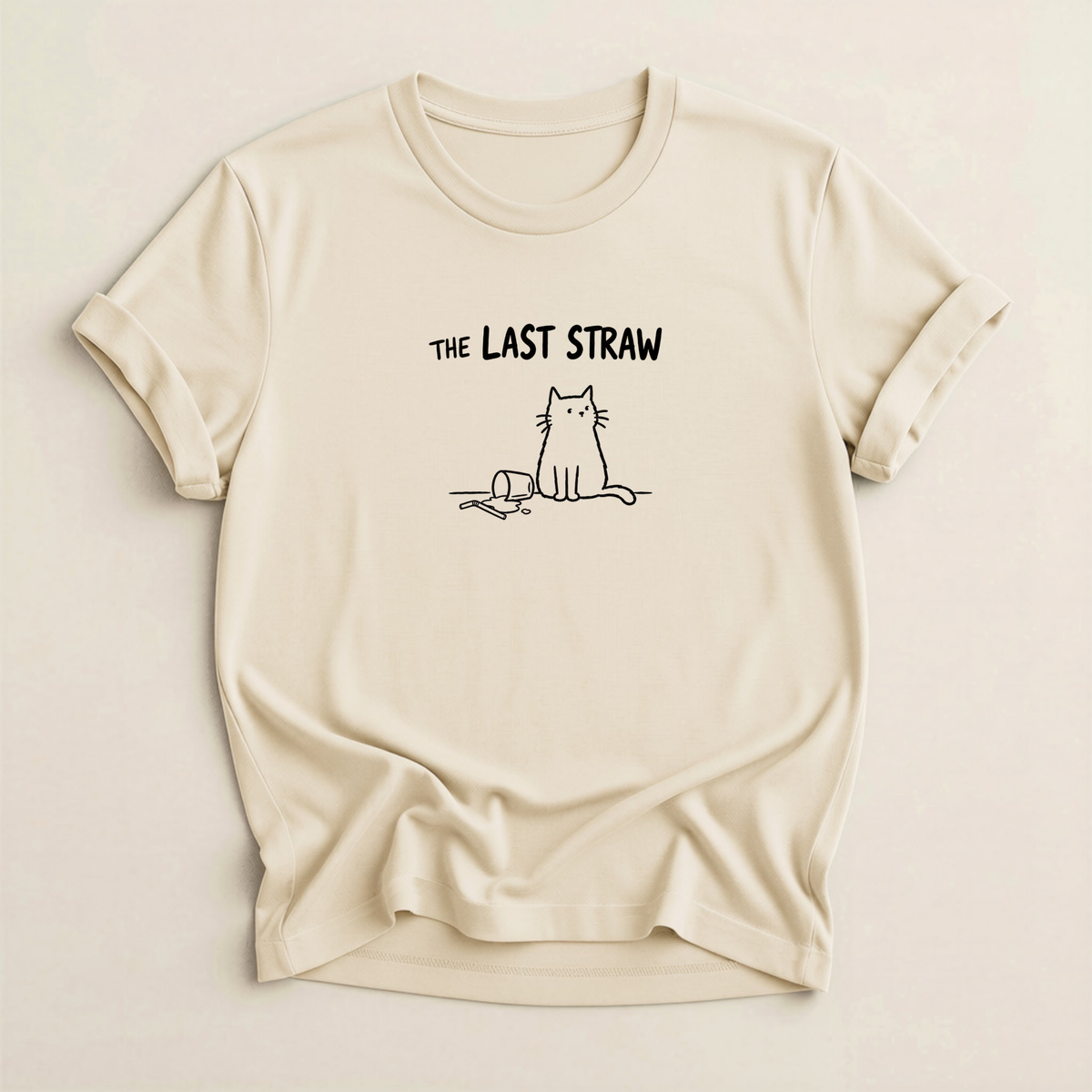 The Last Straw Cat T-Shirt in Natural with black cat and knocked-over glass graphic.
