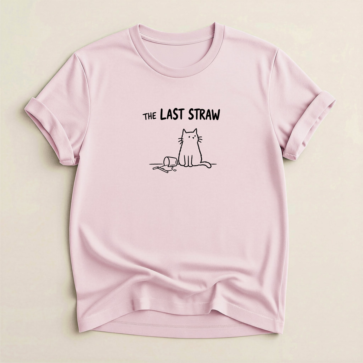 The Last Straw Cat T-Shirt in Soft Pink with black cat and knocked-over glass graphic.